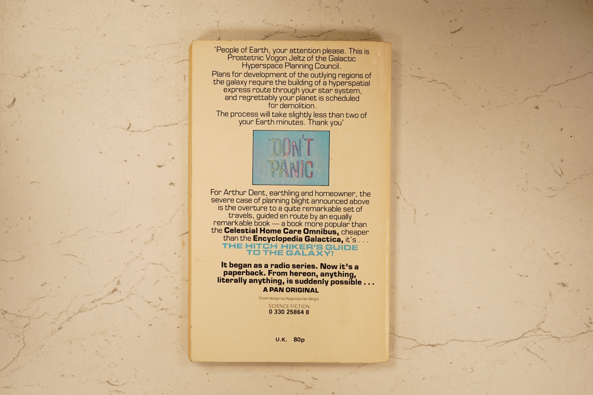 Adams, Douglas - The Hitch Hiker's Guide to the Galaxy. first edition, 2nd printing. half title/radio series leaf; paperback, sm. 8vo. Pan Books, 1979. *published same year as first and with a differently designed cover;